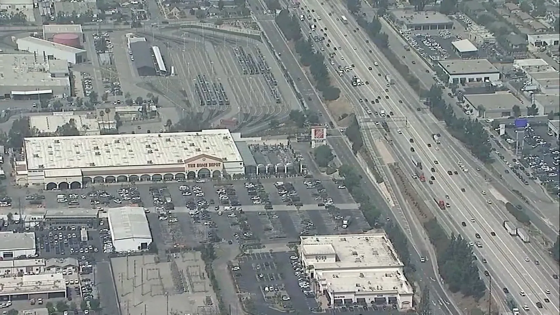 مستودع هوم ديبوت في مونروفيا، كاليفورنيا، مع طريق سريع مزدحم بجانبه، حيث وقعت حادثة مميتة خلال مداهمة لوكالة إنفاذ قوانين الهجرة.