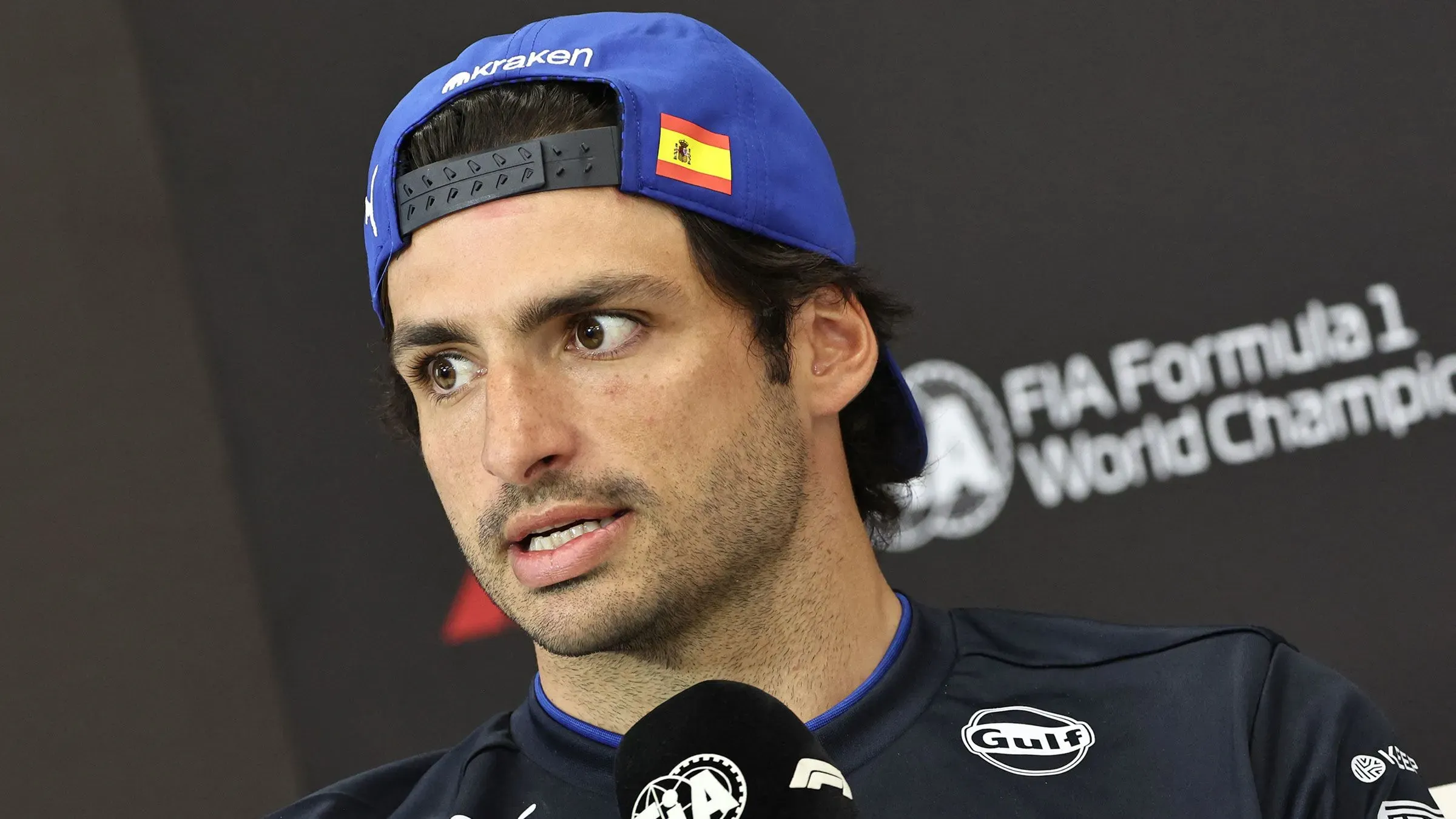 كارلوس ساينز يتحدث في مؤتمر صحفي، معبرًا عن استيائه من غرامة مالية بسبب التأخر عن النشيد الوطني في سباق جائزة اليابان الكبرى.