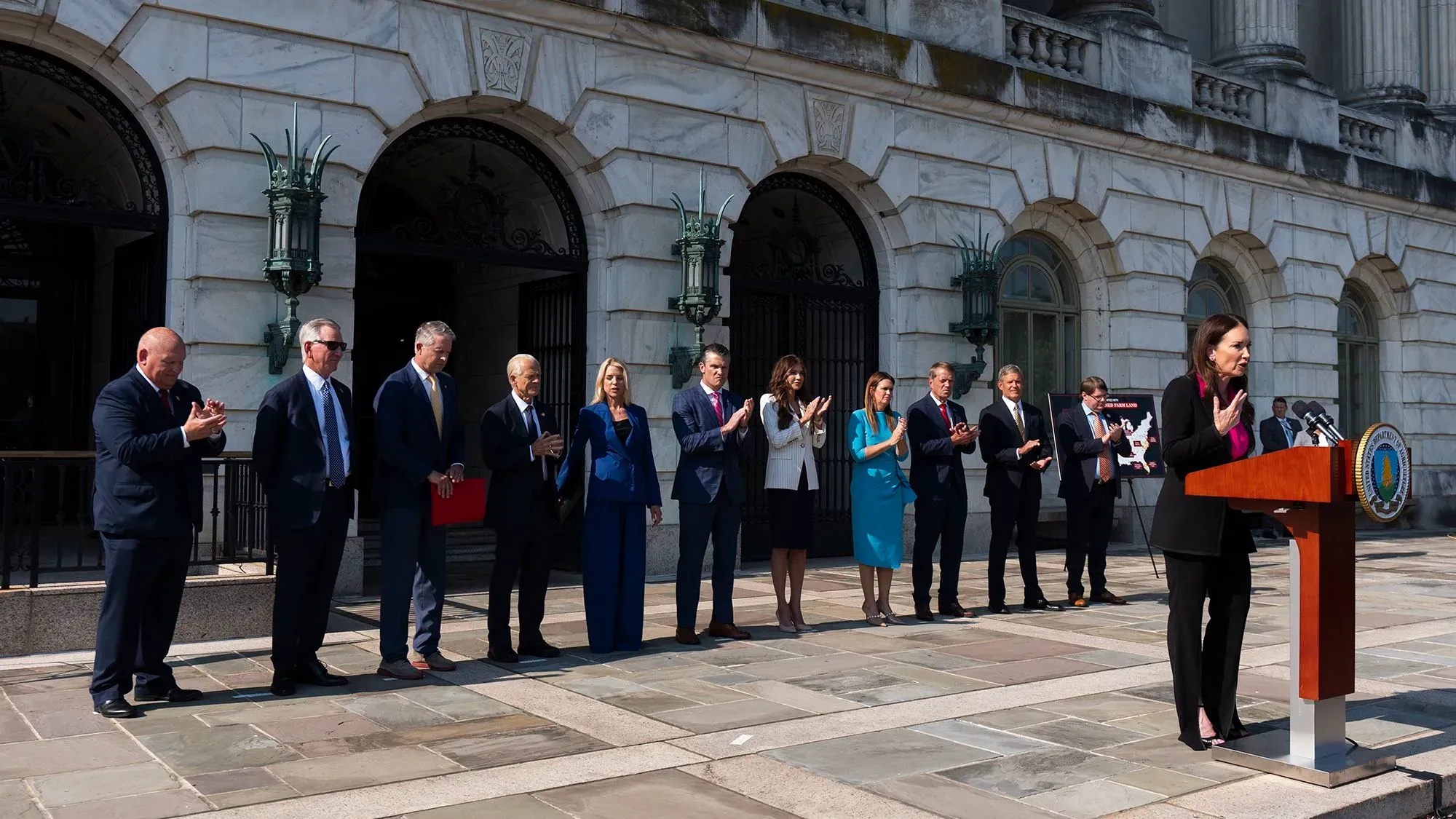 وزير الزراعة بروك رولينز يتحدث خلال مؤتمر صحفي، محاطًا بعدد من المسؤولين، مؤكدًا عدم وجود عفو عن المهاجرين.