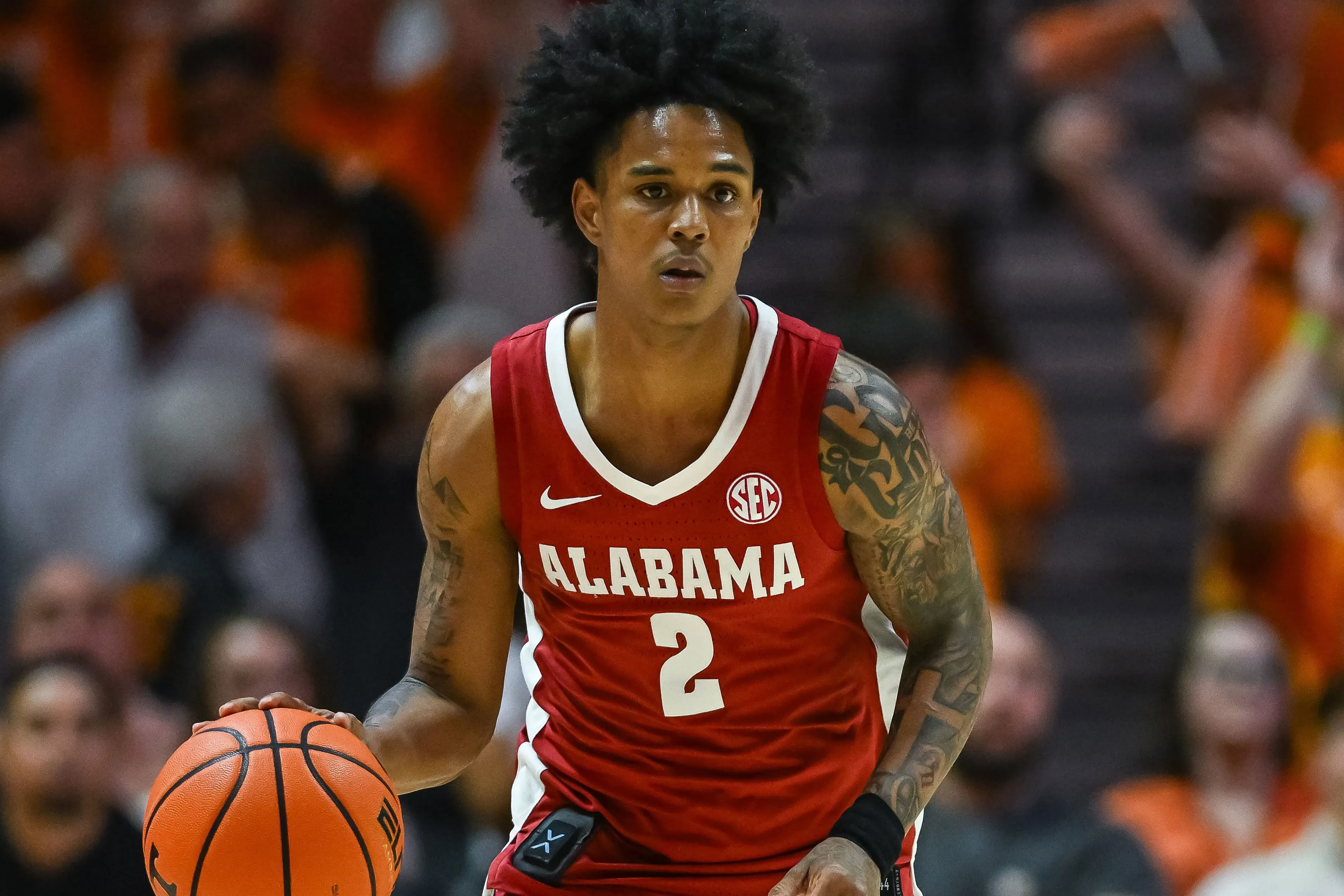 لاعب كرة السلة هولواي من ألاباما يحمل الكرة، يرتدي زي الفريق الأحمر، ويستعد للعب قبل بدء بطولة NCAA.