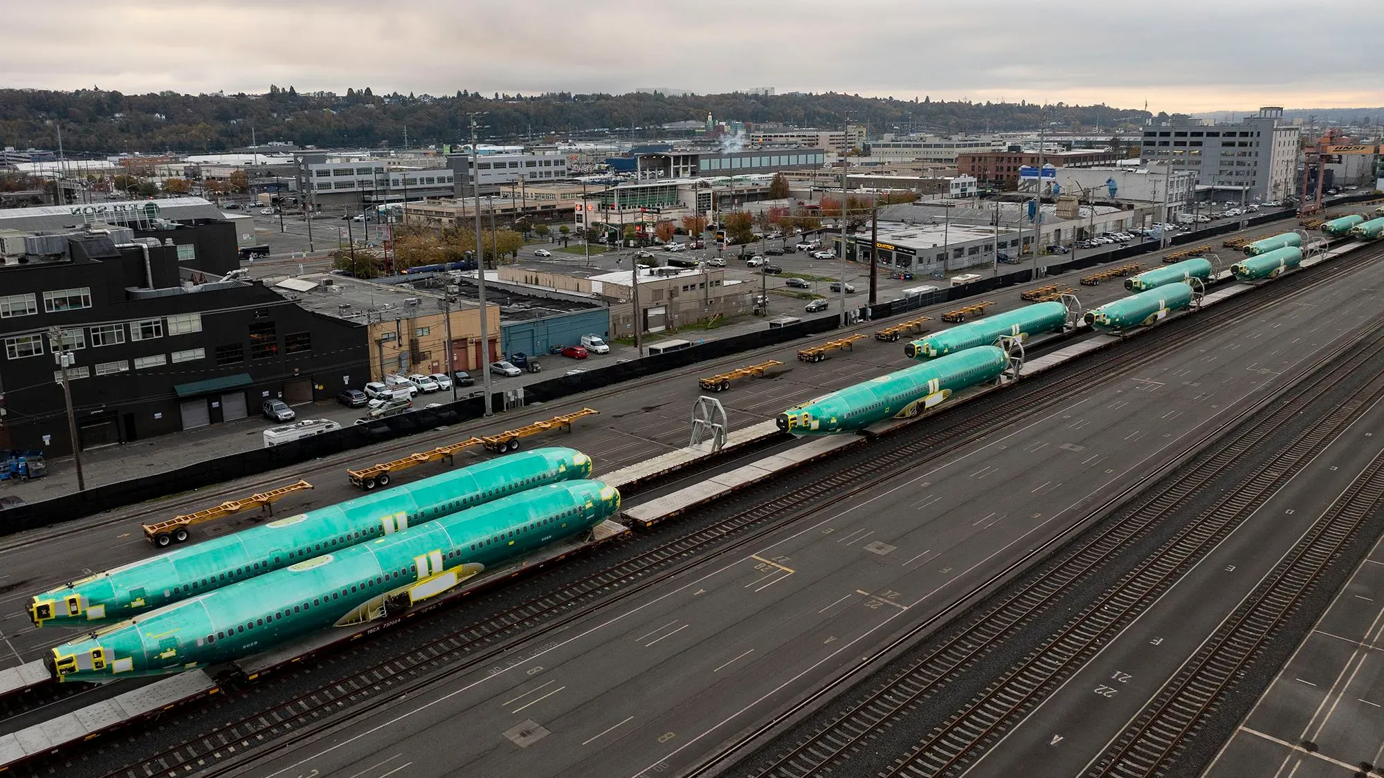 طائرات بوينج 737 ماكس غير المكتملة متوقفة على القضبان، تعكس التحديات التي تواجه الشركة في التعافي من الإضراب وانخفاض الطلبات.