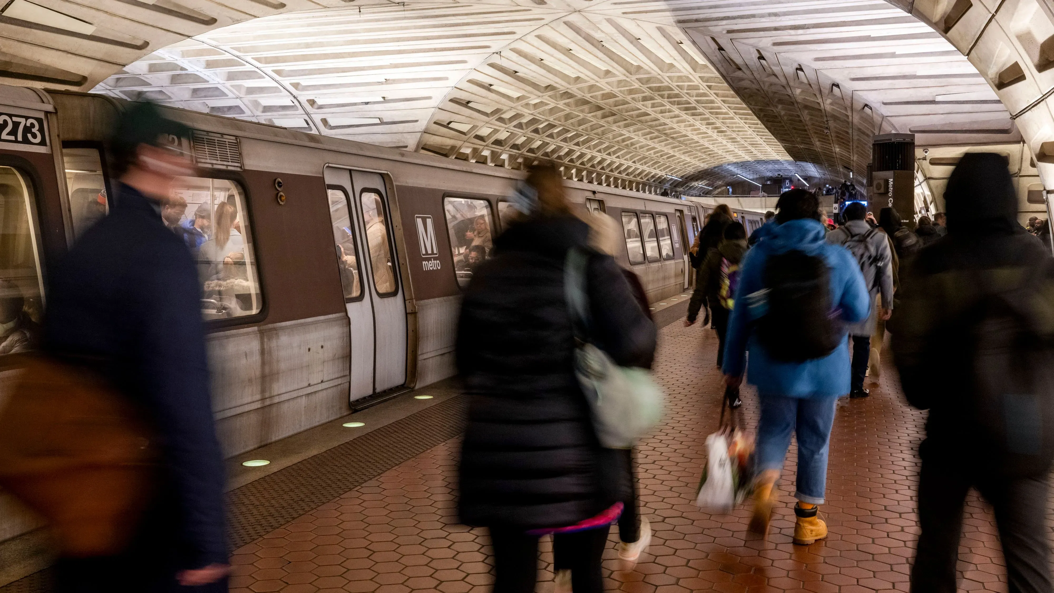 محطة مترو مزدحمة حيث يتجه الركاب نحو القطارات، مما يعكس زيادة الاعتماد على وسائل النقل العام في ظل ارتفاع تكاليف السيارات.