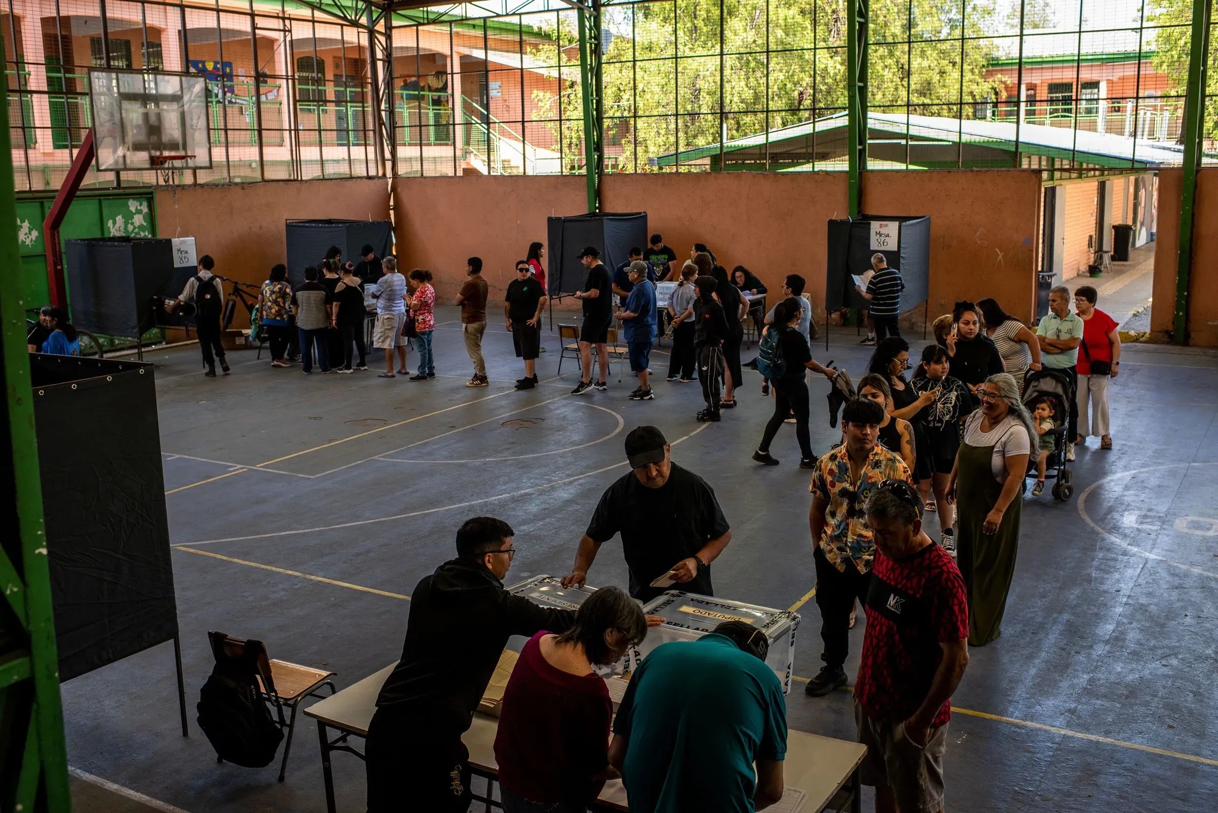 حشود من الناخبين في مركز اقتراع بتشيلي، حيث يتنافس المرشحان جانيت جارا وخوسيه أنطونيو كاست في جولة إعادة رئاسية.