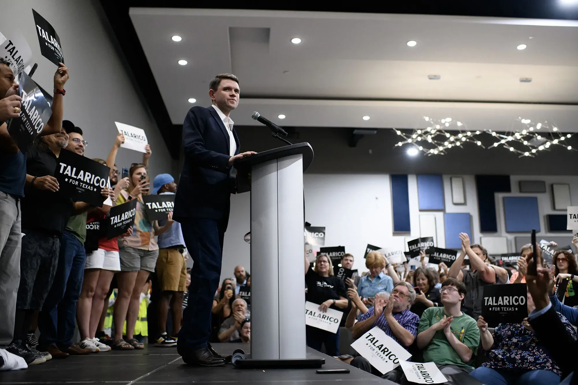 اجتماع حماسي لجيمس تالاريكو، مرشح مجلس الشيوخ في تكساس، مع مؤيديه الذين يحملون لافتات تدعمه، أثناء حديثه على المنصة.