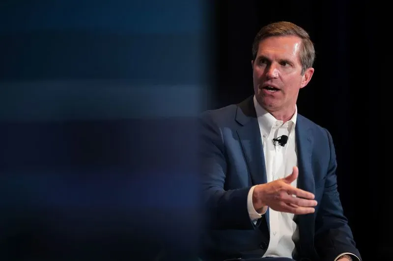 حاكم كنتاكي آندي بيشير يتحدث في مؤتمر، معبرًا عن قلقه بشأن تأثير قانون ترامب على برنامج Medicaid والطبقة العاملة.