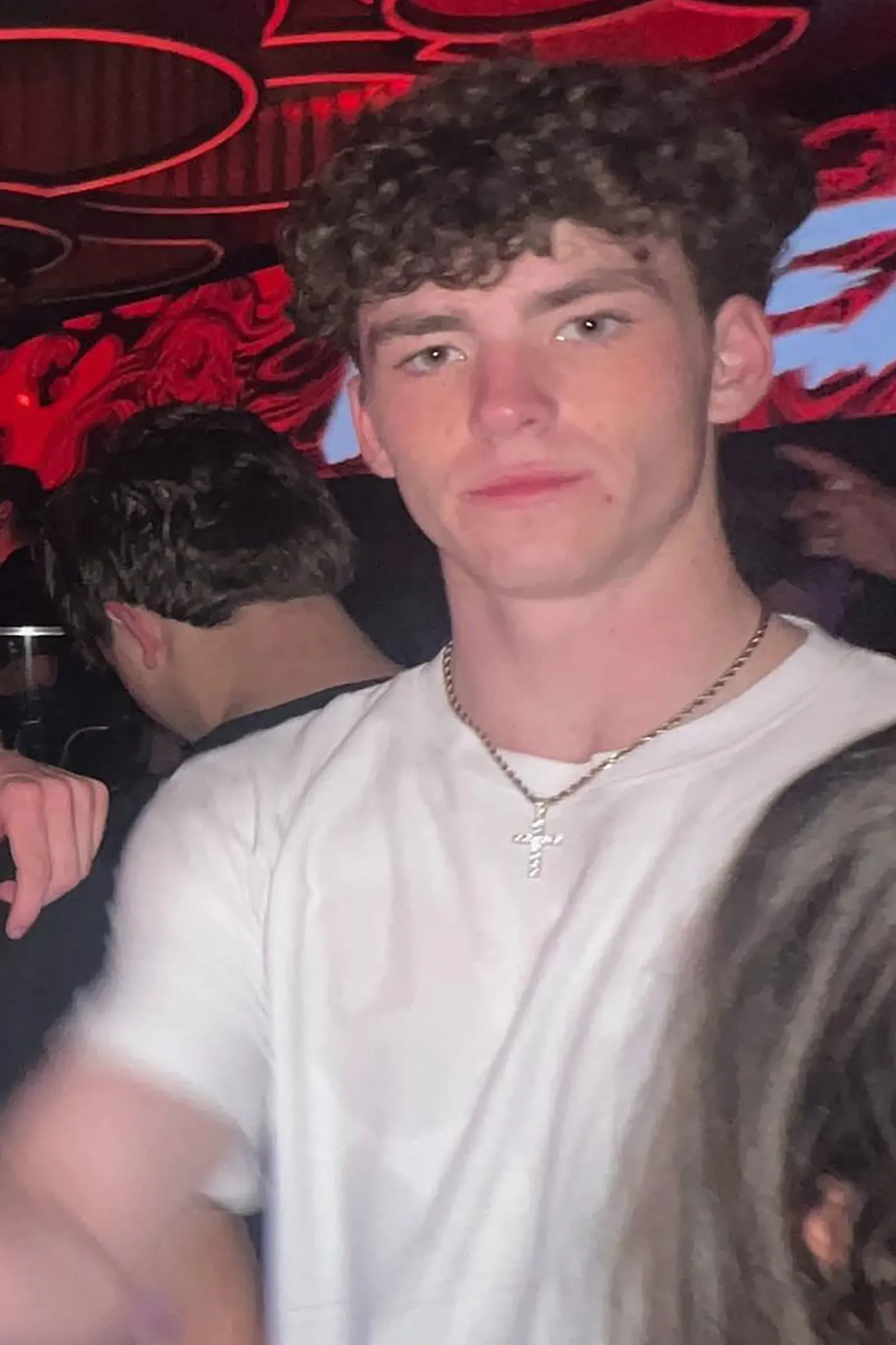 شاب أمريكي يرتدي قميصاً أبيض وسلسلة ذهبية، يظهر في ملهى ليلي في برشلونة، حيث فقد خلال عطلة الربيع.