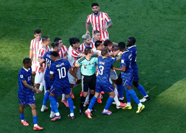 لاعبو منتخب فرنسا وباراغواي يتبادلون الاحتجاجات مع حكم المباراة خلال مواجهة حاسمة في كأس العالم 2022.