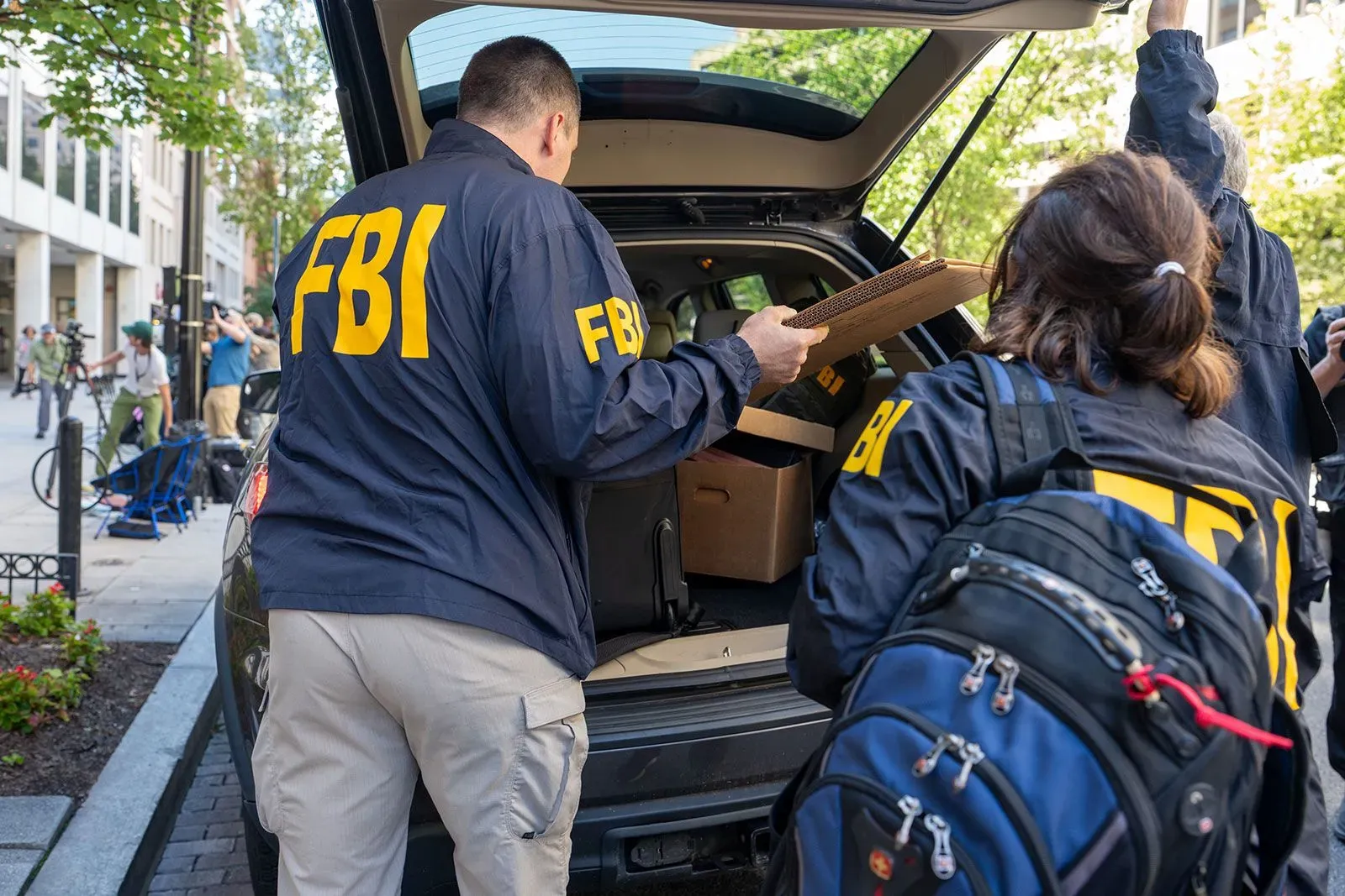 عملاء من مكتب التحقيقات الفيدرالي يجمعون مستندات من سيارة أثناء تفتيش منزل جون بولتون في ماريلاند، في إطار تحقيق حول سجلات سرية.