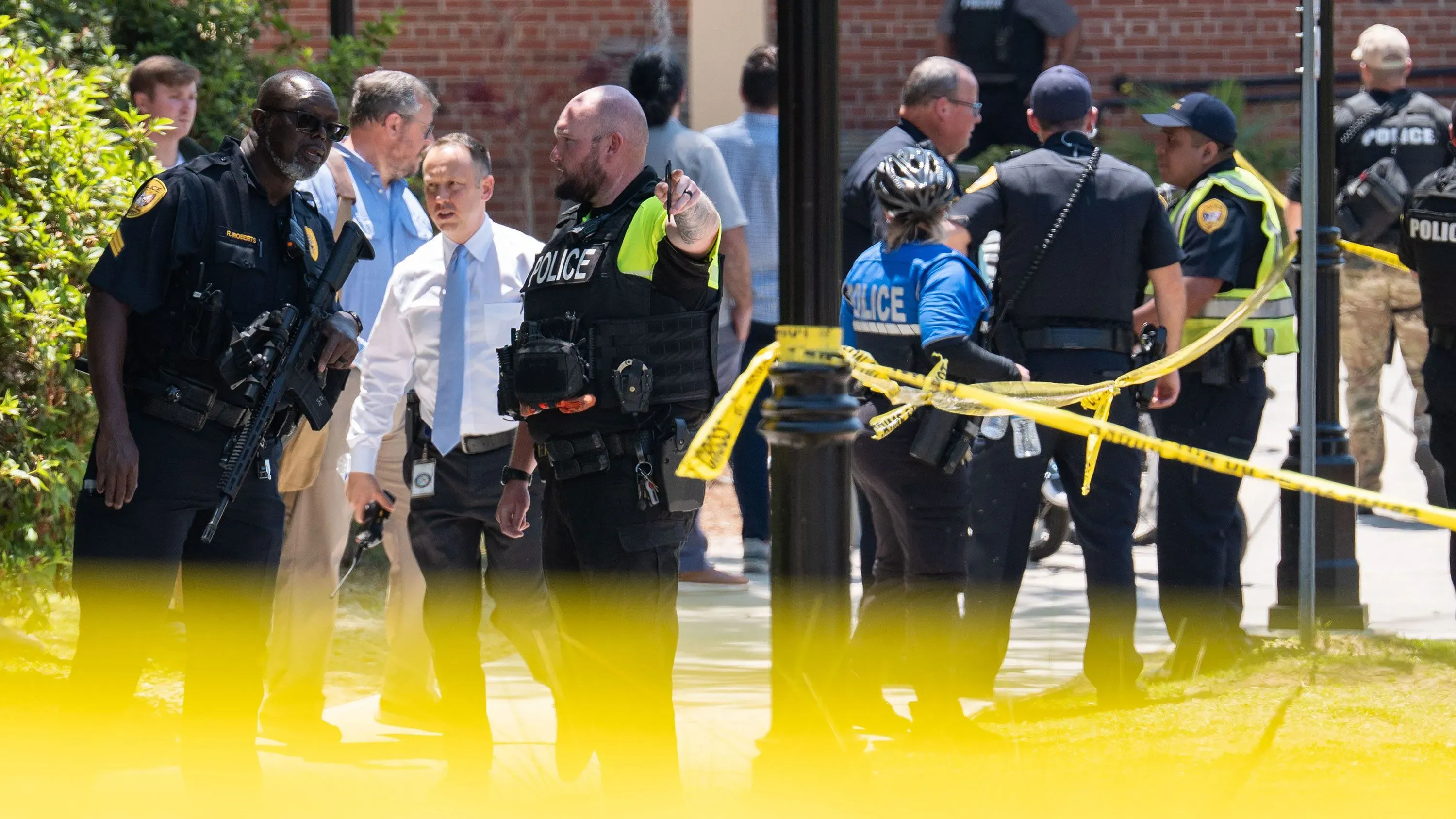 تواجد عناصر الشرطة في موقع حادث إطلاق النار بجامعة ولاية فلوريدا، مع وجود حواجز وتحذيرات، مما يعكس حالة الطوارئ والقلق بين الطلاب.