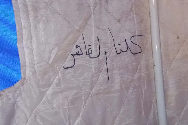 كتابة على قماش خيمة في مخيم للنازحين داخلياً، تظهر عبارة "كنا الفاشر"، تعبر عن ماضي الأشخاص الذين فقدوا منازلهم بسبب النزاع.