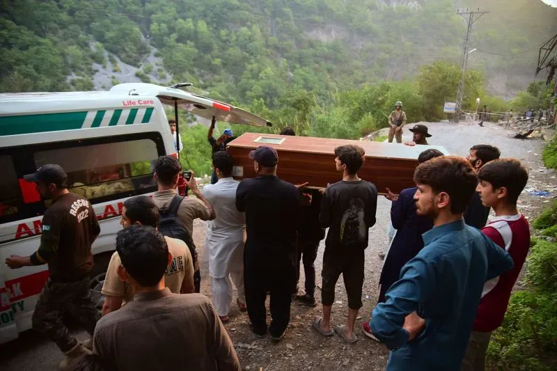تجمع عدد من الأشخاص حول سيارة إسعاف بينما يحملون نعشًا في منطقة جبلية بكشمير، في سياق تصعيد التوترات بين الهند وباكستان.