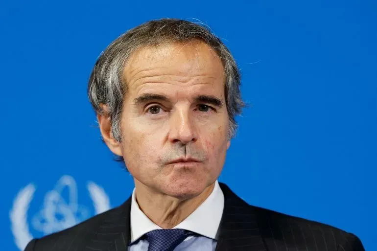 مدير الوكالة الدولية للطاقة الذرية، رافائيل غروسي، يتحدث في مؤتمر صحفي، مع خلفية زرقاء، وسط توترات بشأن البرنامج النووي الإيراني.