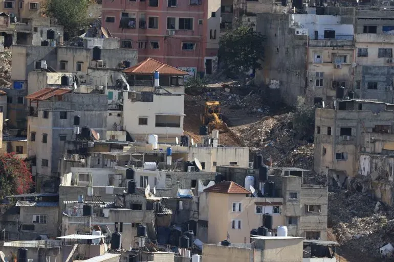 منازل مدمرة في منطقة مكتظة بالسكان في الضفة الغربية، تعكس آثار التهجير وهدم المنازل بسبب التوترات المستمرة.