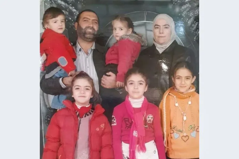 عائلة مكونة من ستة أطفال ووالديهم، يظهرون في صورة عائلية، تعكس معاناة المختفين قسراً في سوريا خلال حكم الأسد.