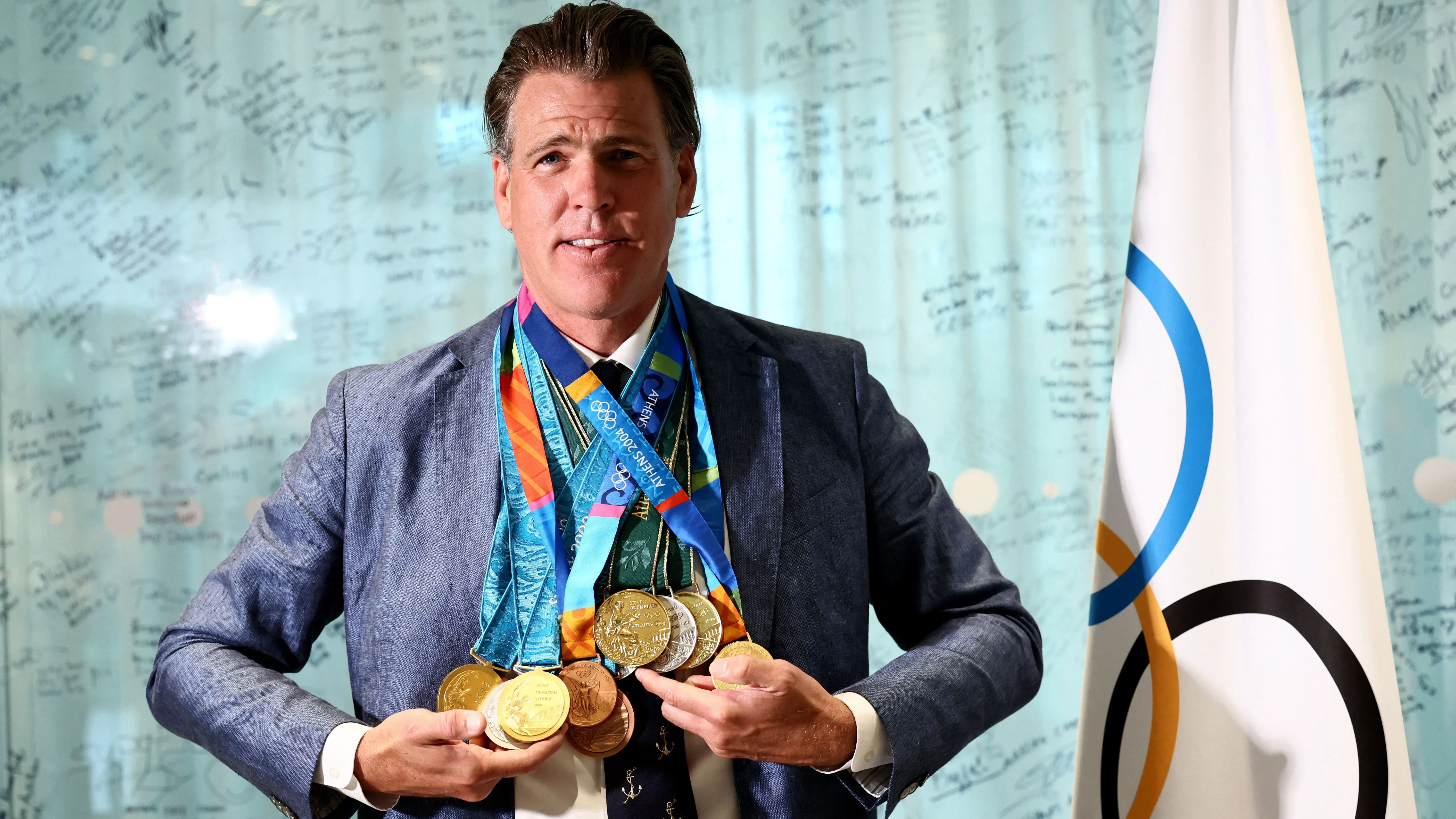 غاري هول جونيور يحمل ميدالياته الأولمبية الجديدة، بما في ذلك خمس ذهبيات وثلاث فضيات وبرونزيتين، بعد استبدال الميداليات المحترقة.