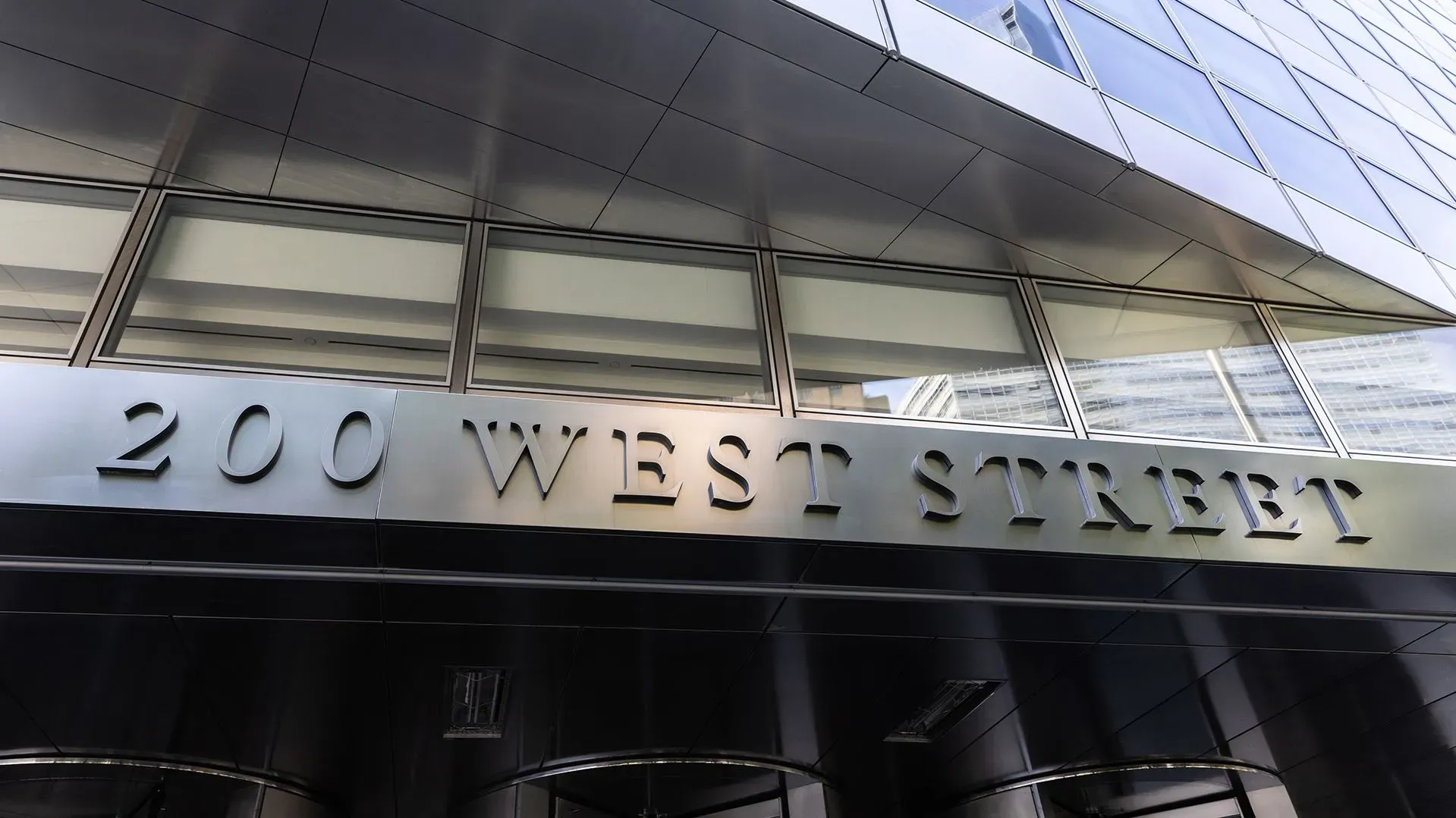 واجهة مبنى بنك جولدمان ساكس في 200 ويست ستريت، تعكس تأثير التعريفات الجمركية على الاقتصاد الأمريكي.