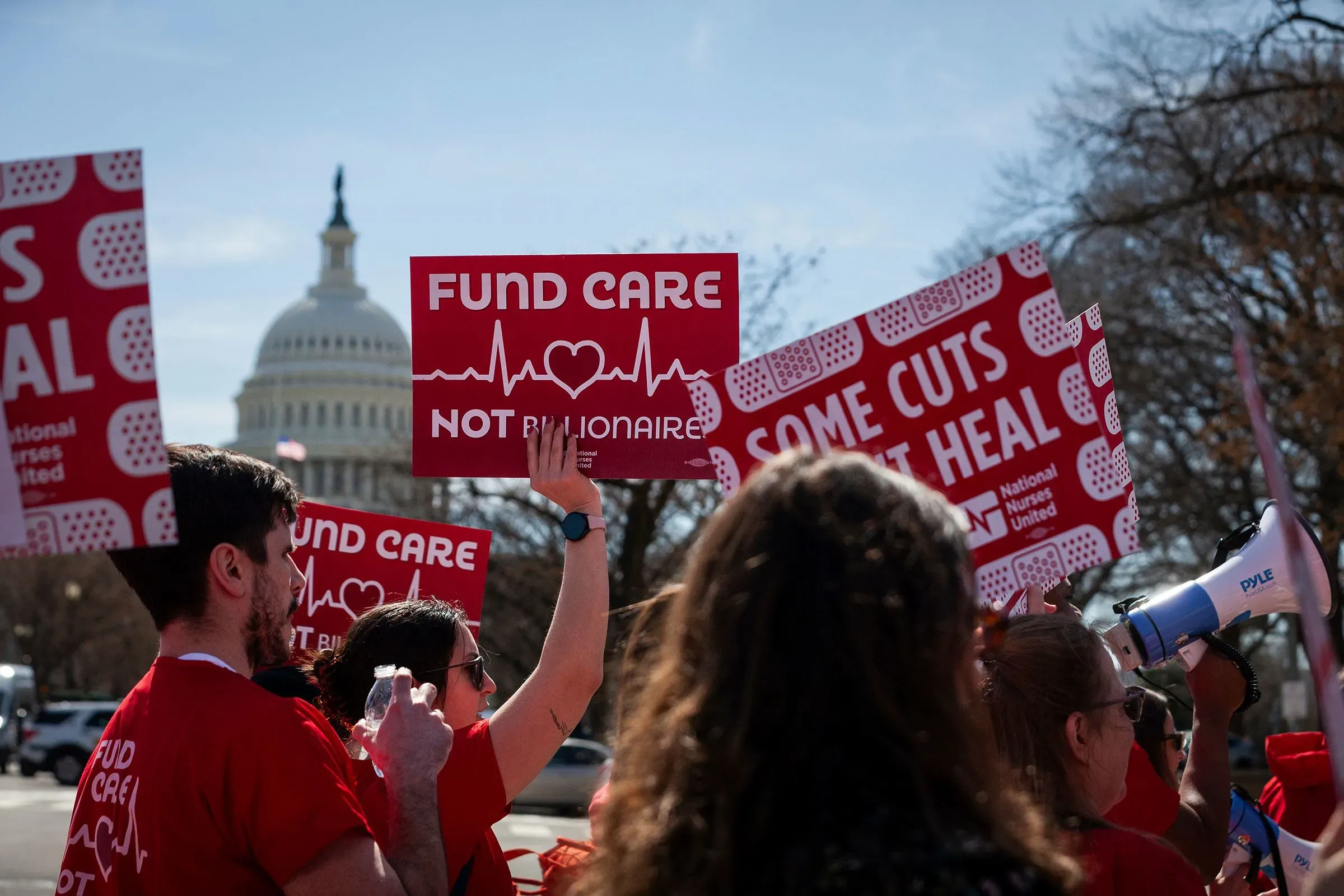 تظاهرة أمام مبنى الكابيتول الأمريكي تطالب بتمويل الرعاية الصحية، مع لافتات تحمل شعارات مثل "موّل الرعاية وليس المليارديرات".
