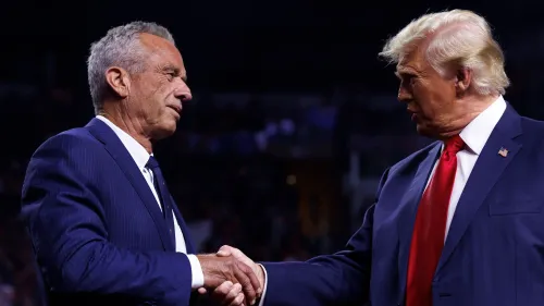 روبرت ف. كينيدي يتصافح مع الرئيس دونالد ترامب خلال حدث، حيث تتصاعد المخاوف بشأن الثقة في الصحة العامة والسياسات الصحية.