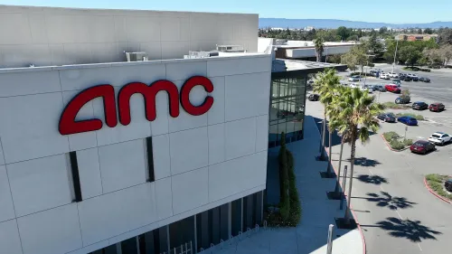 واجهة سينما AMC مع شعار الشركة، تُظهر مواقف السيارات المحيطة والمباني المجاورة، تعكس التحسينات الجديدة في تجربة رواد السينما.