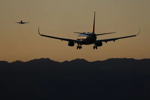 طائرتان تجاريتان تحلقان في السماء عند غروب الشمس، مما يعكس أهمية الصحة العقلية للطيارين في سياق مشروع قانون إصلاح القواعد.