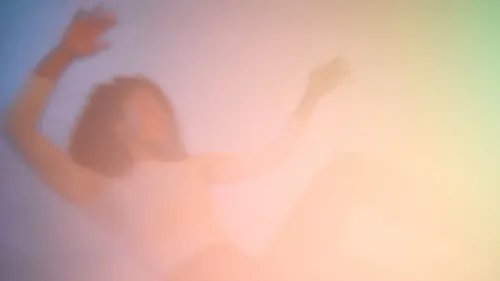 صورة ضبابية لامرأة مستلقية، تعبر عن تجربة العلاج بالكيتامين وتأثيراته على الصحة العقلية، في سياق حديث عن العلاج النفسي.