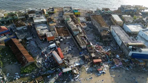 تظهر الصورة مشهدًا جويًا لمدينة دمرها إعصار ميليسا، حيث تضررت المباني بشدة وتنتشر الحطام على الأرض، مما يعكس آثار الكارثة.