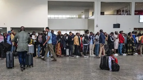 طابور طويل من الناس ينتظرون عند نقطة عبور الحدود مع رواندا، محملين بالأمتعة، في سياق تصاعد التوترات الأمنية في غوما.