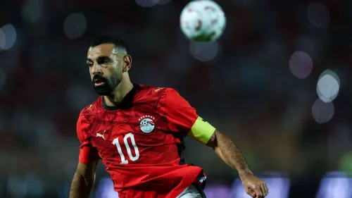 محمد صلاح قائد منتخب مصر يرتدي شارة القيادة ويركز على الكرة خلال مباراة رسمية، في ظل أزمة غيابه عن مباريات المنتخب الأخيرة.