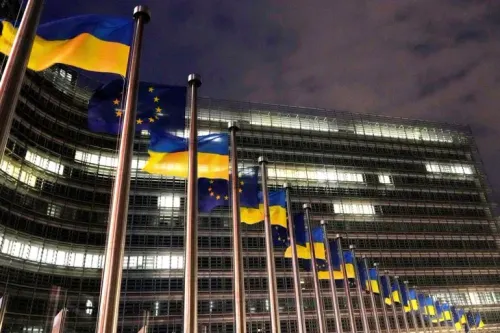 أعلام أوكرانيا والاتحاد الأوروبي ترفرف أمام مبنى الاتحاد الأوروبي في بروكسل، تعبيراً عن دعم القرض لأوكرانيا في ظل التغيرات السياسية.