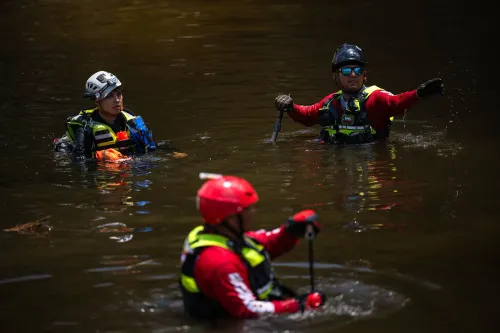رجال إطفاء مكسيكيون في مياه نهر غوادالوبي، يعملون على البحث والإنقاذ بعد الفيضانات، مع التركيز على جهودهم الإنسانية.