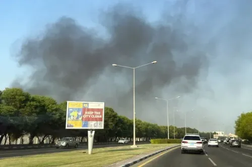 تصاعد أعمدة دخان كثيف فوق أفق الدوحة بعد الهجمات الإسرائيلية، مع وجود لافتة تشير إلى أهمية الحفاظ على نظافة المدينة.