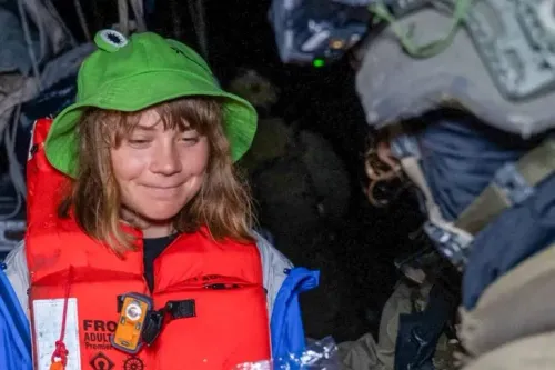 غريتا ثونبرغ ترتدي سترة نجاة وقبعة، مبتسمة أثناء احتجازها من قبل القوات الإسرائيلية بعد اعتراض السفينة "مدلين" التي كانت تحمل مساعدات لغزة.