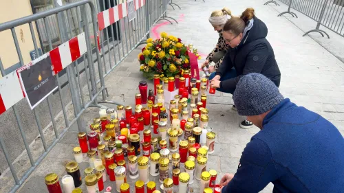 أشخاص يضيئون الشموع ويضعون الزهور تكريمًا لضحايا هجوم طعن في فيلاخ، النمسا، وسط أجواء من الحزن والتأمل.