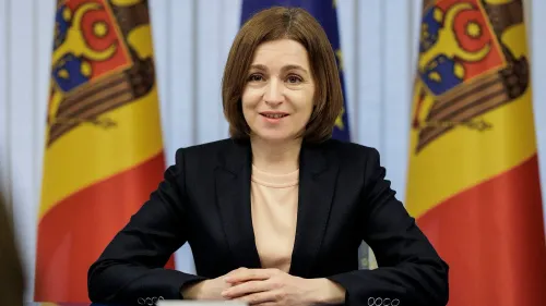 مايا ساندو، رئيسة مولدوفا، تتحدث في مؤتمر صحفي، مع العلمين الوطنيين خلفها، في سياق الانتخابات البرلمانية والتدخل الروسي.