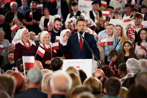 تجمع حشد من المؤيدين حول مرشح حزب الشعب البولندي، رافا ترزاسكوفسكي، خلال خطابه الانتخابي، مع أعلام بولندية في الأيدي.