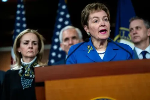 امرأة تتحدث أمام ميكروفونات في مؤتمر صحفي، بينما يظهر خلفها عدد من الأشخاص. تعكس الصورة أهمية إعادة تقسيم الدوائر الانتخابية.