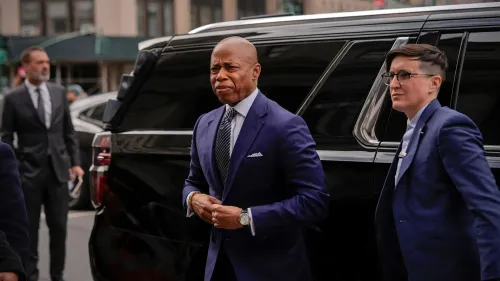 يظهر العمدة إريك آدامز وهو يغادر سيارة ليموزين، برفقة مساعدته، في سياق إعلان حاكمة نيويورك عن تغييرات إدارية جديدة.