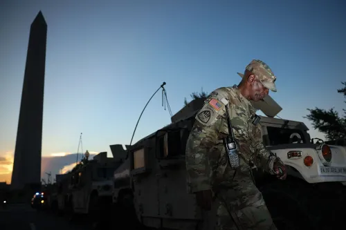 جنود يرتدون زيًا عسكريًا بالقرب من مركبات عسكرية تحت نصب واشنطن، في سياق جهود ترامب لتعزيز إنفاذ القانون في المدن الكبرى.