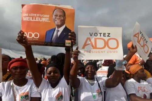 مؤيدو المرشح الرئاسي تيجان تيام يتظاهرون في أبيدجان، حاملين لافتات تحمل شعارات دعم، وسط أجواء من الأمطار والقلق السياسي.