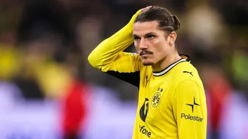 لاعب وسط بوروسيا دورتموند مارسيل سابيتزر يرتدي قميص الفريق الأصفر خلال مباراة، مع تسليط الضوء على احتمالية انتقاله إلى بولونيا رغم التحديات المالية والرياضية.