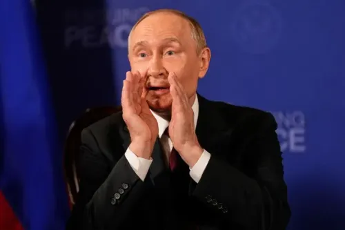 فلاديمير بوتين يتحدث بحماس خلال مؤتمر صحفي، مع وجود علم روسيا خلفه، في سياق محادثات السلام حول أوكرانيا.