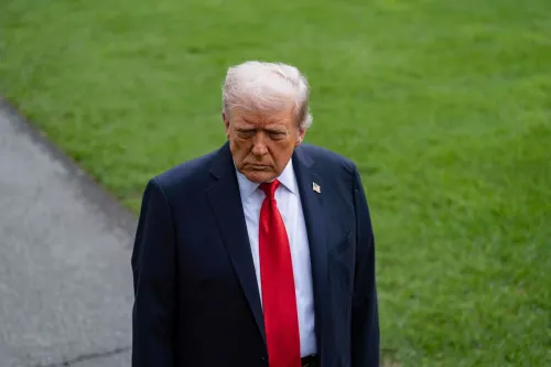 ترامب يسير بخطوات واثقة، مرتديًا بدلة داكنة وربطة عنق حمراء، مع تعبير وجه يعكس الجدية، في خلفية خضراء تعزز التركيز على ملامحه.