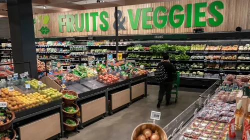 تظهر الصورة قسم الفواكه والخضروات في سوبرماركت، حيث يتم عرض مجموعة متنوعة من الفواكه والخضروات الطازجة.