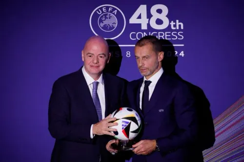 رئيسا FIFA وUEFA يحملان كرة قدم رسمية خلال المؤتمر الـ48 للاتحاد الأوروبي، في سياق النزاع القانوني حول مشروع FIFA Forward Enterprise.