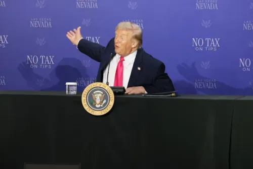 الرئيس الأمريكي السابق دونالد ترامب يتحدث خلال مؤتمر صحفي في لاس فيغاس، مع وجود شعار "لا ضرائب على الإكراميات" خلفه.