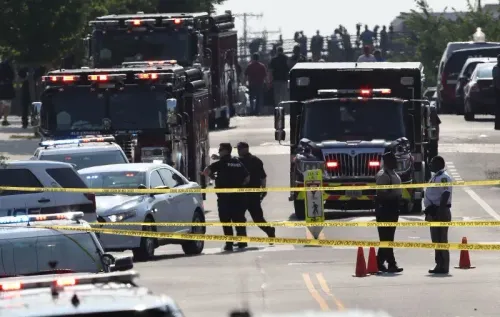 مركبات الطوارئ وعناصر الشرطة في موقع حادث إطلاق نار، مع وجود شريط تحذيري، مما يعكس حالة الطوارئ والتهديدات الأمنية للمشرعين.