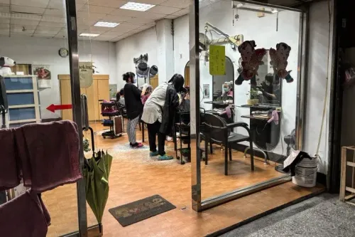 صالون حلاقة في تايبيه الجديدة، حيث تتفاعل الزبائن مع مصففي الشعر، تعبيرًا عن الحياة اليومية وسط التوترات العسكرية مع الصين.