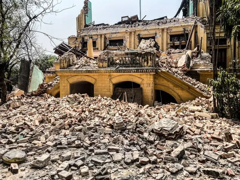 تظهر الصورة مبنى منهار محاط بأكوام من الحطام، مما يعكس الدمار الواسع الذي خلفه الزلزال في ساغاينغ.