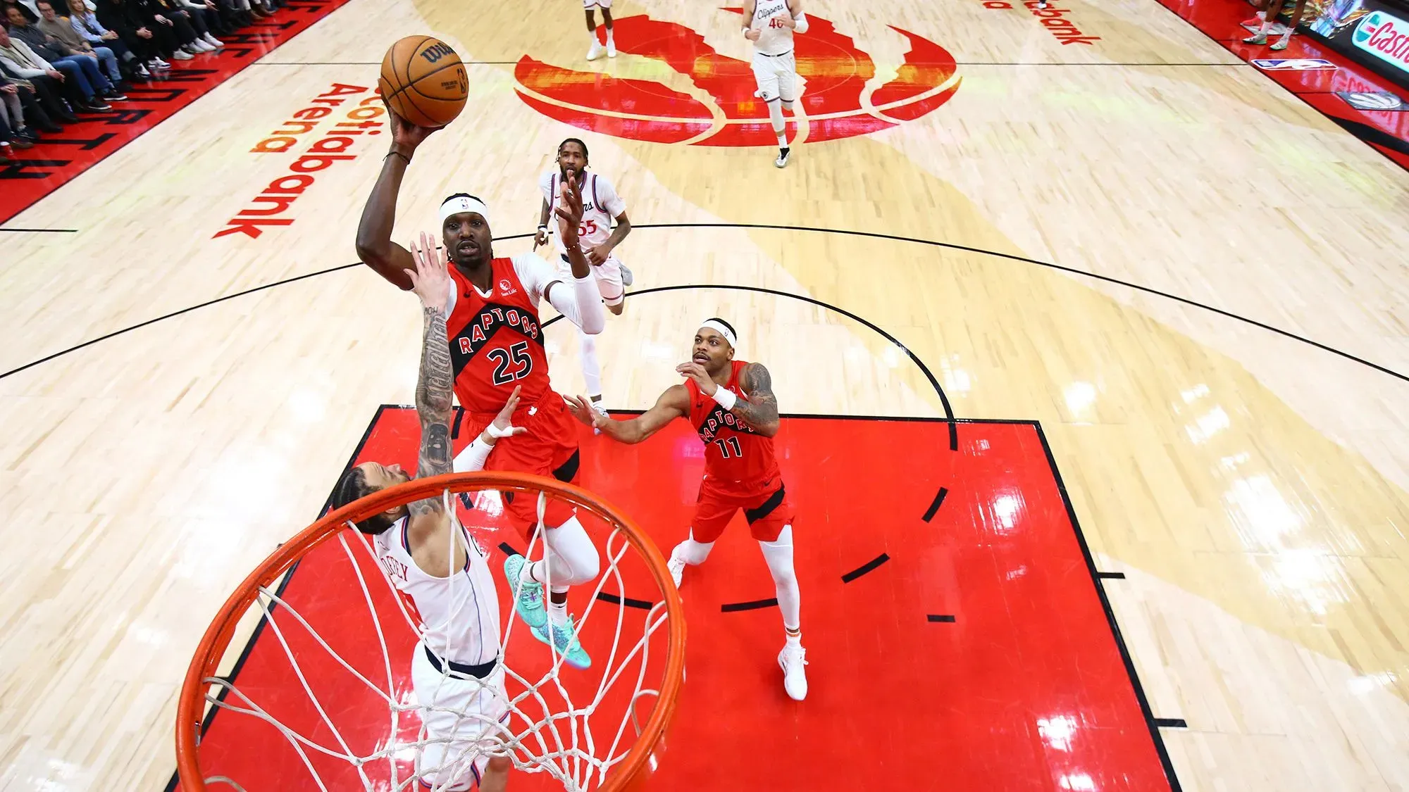 لاعبو تورونتو رابتورز في مباراة كرة سلة، مع كرة في الهواء، خلال مواجهة مع لوس أنجلوس كليبرز في ملعب سكوتiabank أرينا.