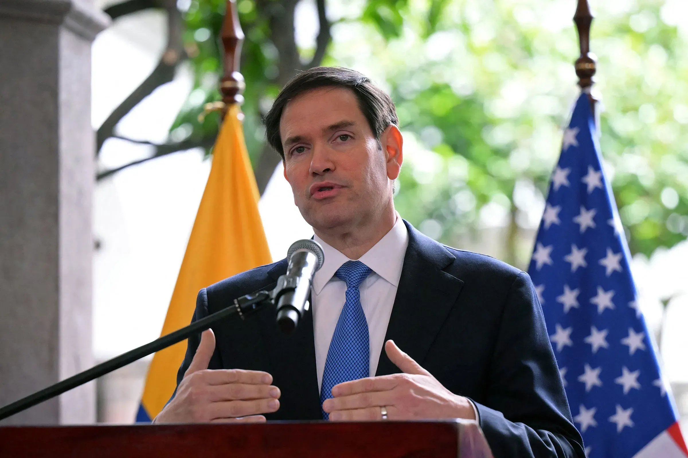 وزير الخارجية الأمريكي ماركو روبيو يتحدث في كيتو، مع العلمين الإكوادوري والأمريكي خلفه، حول تصنيف جماعات إجرامية كإرهابية.